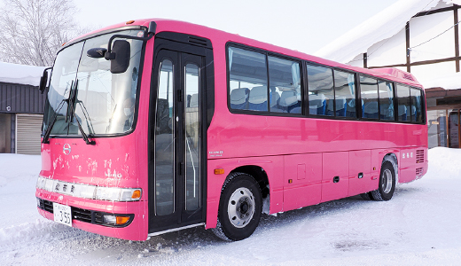 The bus stop is located at the left corner of the bicycle parking lot in front of the station.
